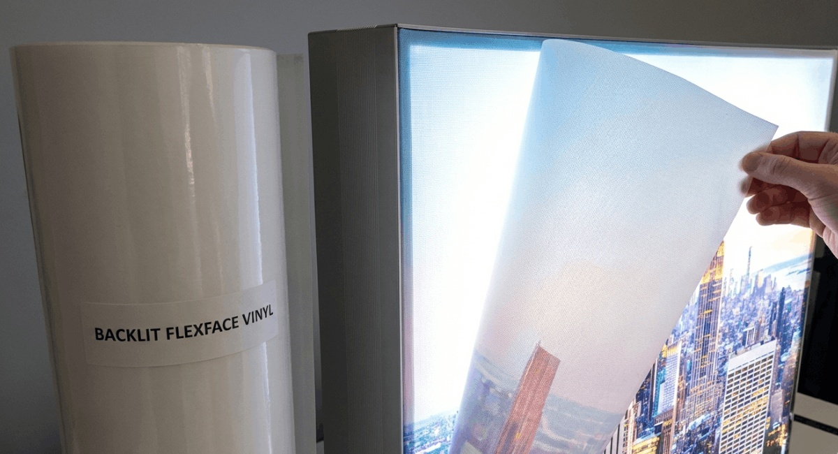 “Backlit flexface signage glowing with LED lights, showing clear digital media printing on GSM backlit textile material.”